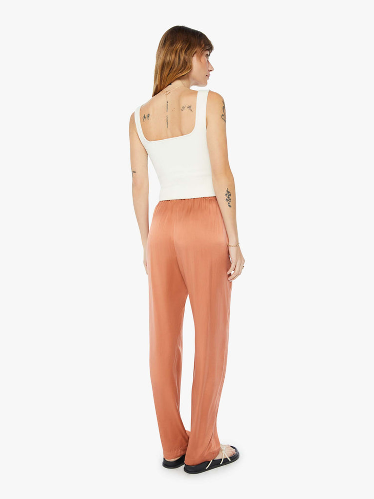 Back  view of woman burnt orange high rise, elastic waist and a loose, flowy fit pant.