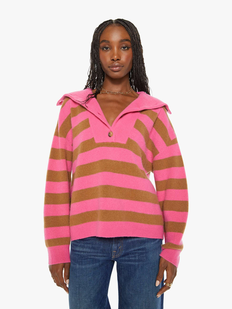 Front view of a woman oversized collar, buttoned V-neck, long balloon sleeves and a loose fit sweater in a hot pink and brown stripe pattern.