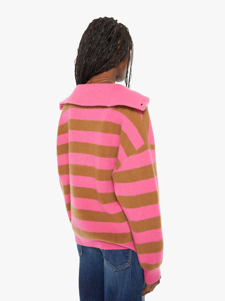 Back view of a woman oversized collar, buttoned V-neck, long balloon sleeves and a loose fit sweater in a hot pink and brown stripe pattern.