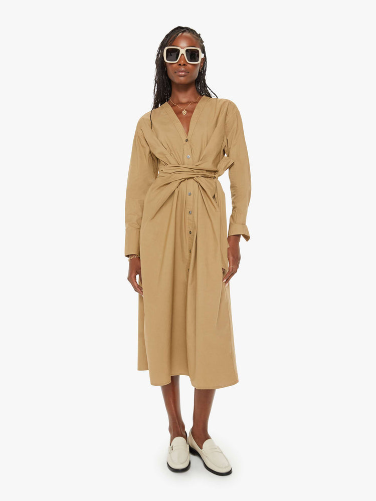 Front view of a woman dark khaki dress with a V-neck, drop shoulders, long sleeves, a tied waist, buttons down the front and a calf-length hem.