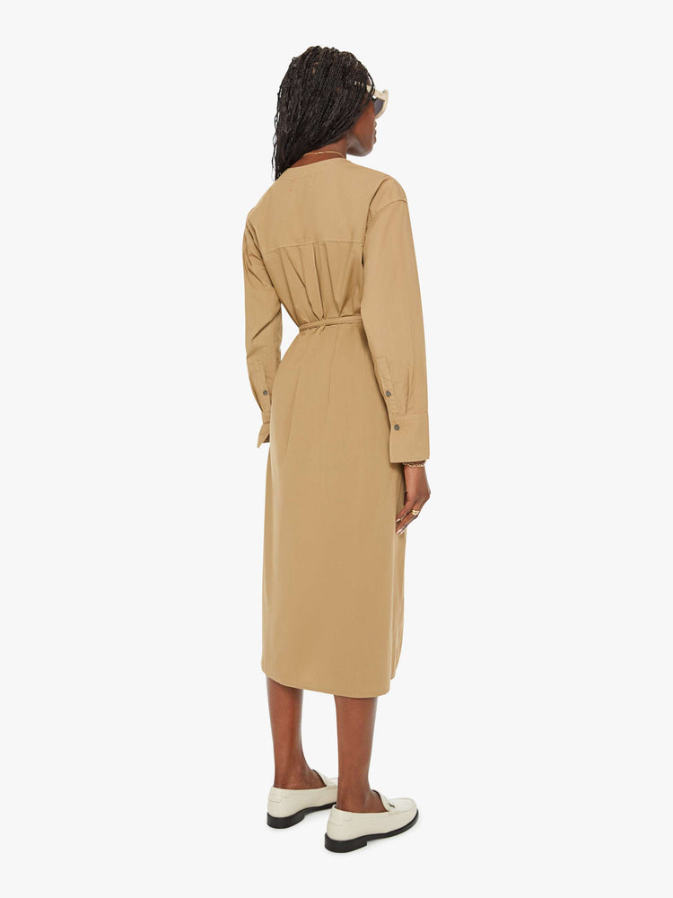 Back view of a woman dark khaki dress with a V-neck, drop shoulders, long sleeves, a tied waist, buttons down the front and a calf-length hem.