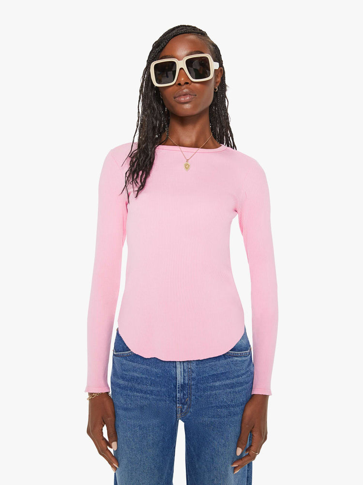 Front view of a woman baby pink long-sleeve tee features a crewneck and curved hem with a slim fit.