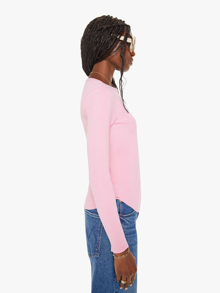 Side view of a woman baby pink long-sleeve tee features a crewneck and curved hem with a slim fit.