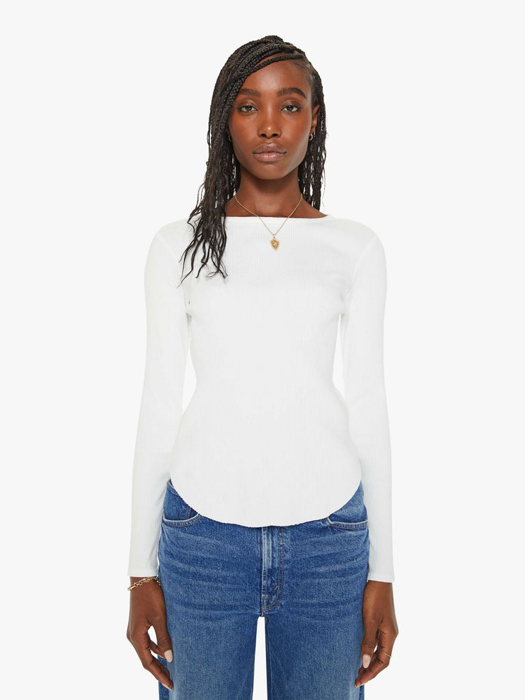 Front view of a woman white long-sleeve tee features a crewneck and curved hem with a slim fit.