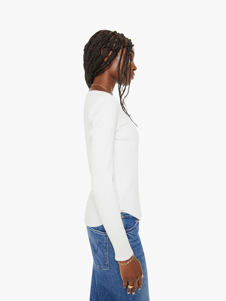 Side view of a woman white long-sleeve tee features a crewneck and curved hem with a slim fit.