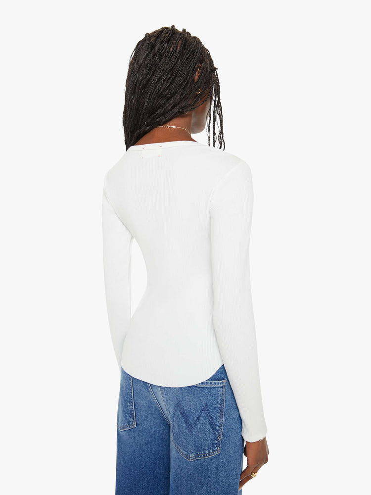 Back view of a woman white long-sleeve tee features a crewneck and curved hem with a slim fit.