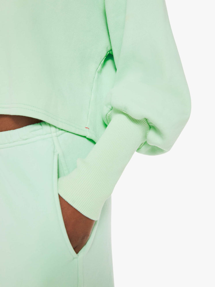 Swatch view of a woman minty- green hue crewneck sweatshirt with drop shoulders, bat-wing sleeves, extra-long ribbed hems at the wrists and a cropped, oversized fit.