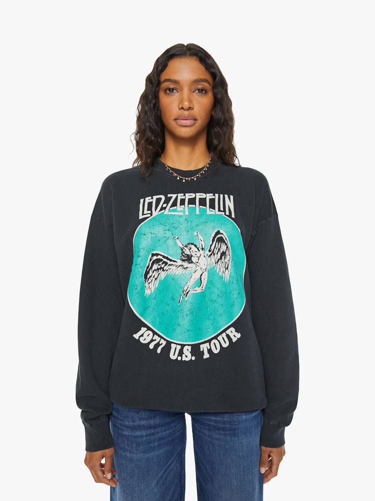 WOMEN front view of a black sweatshirt  pays homage to Led Zeppelin's 1977 tour with a faded green Icarus graphic with text in white on the front.