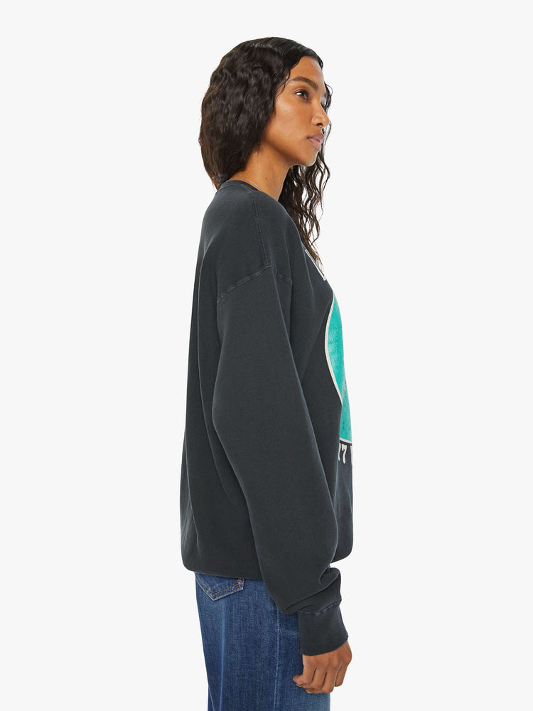 WOMEN side view of a black sweatshirt pays homage to Led Zeppelin's 1977 tour with a faded green Icarus graphic with text in white on the front.