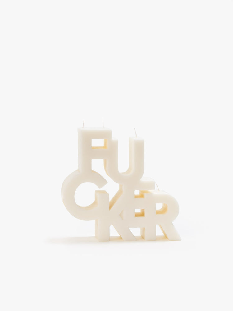 Image of an off white candle made up of stacked letters reading "FUCKER".