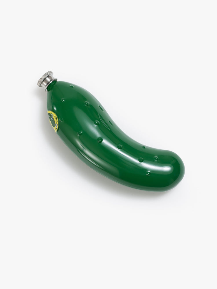 Flat of a green metal flask in the shape of a dill pickle.