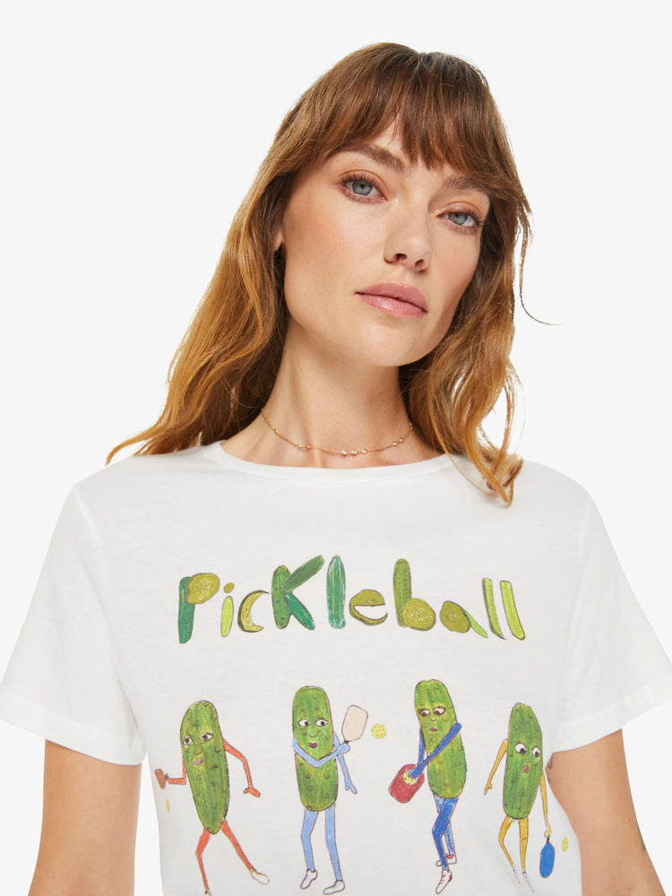 Close up view of a woman white tee features a colorful hand-drawn pickleball graphic on the front.