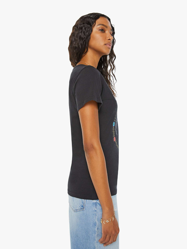 Side view of a woman black tee features a colorful, hand-drawn graphic depicting the Aries ram.