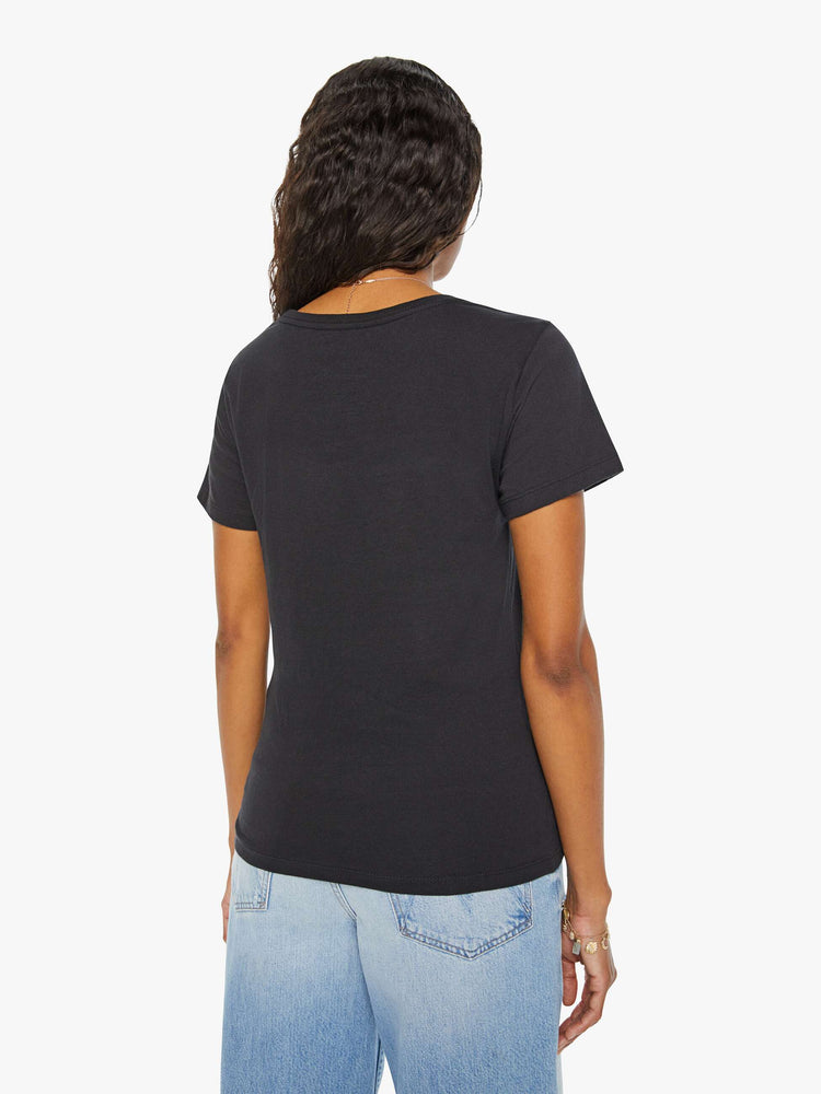 Back view of a woman black tee features a colorful, hand-drawn graphic depicting the Aries ram.