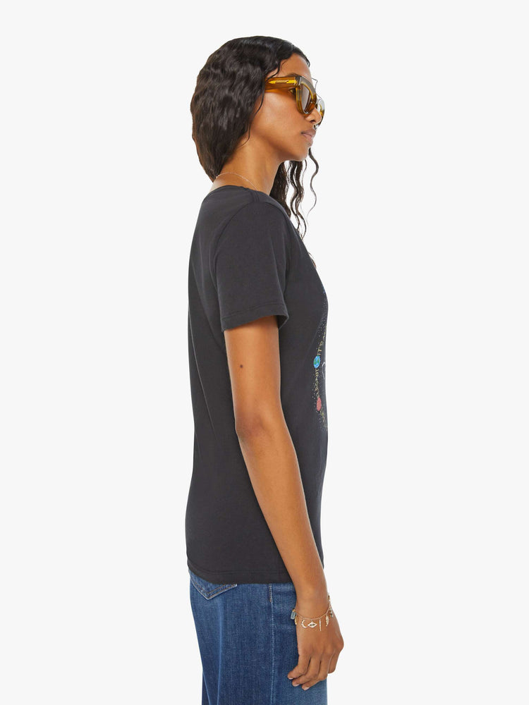 Side view of a woman black tee eatures a colorful, hand-drawn graphic depicting the Taurus bull, the earthly second astrological sign in the zodiac.