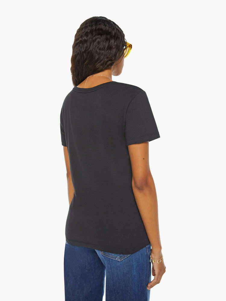 Back view of a woman black tee eatures a colorful, hand-drawn graphic depicting the Taurus bull, the earthly second astrological sign in the zodiac.