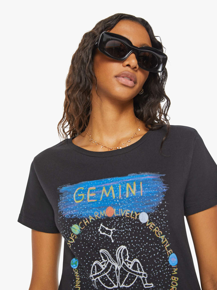 Close up  view of a woman black tee features the twins of the Gemini, the third astrological sign in the zodiac.