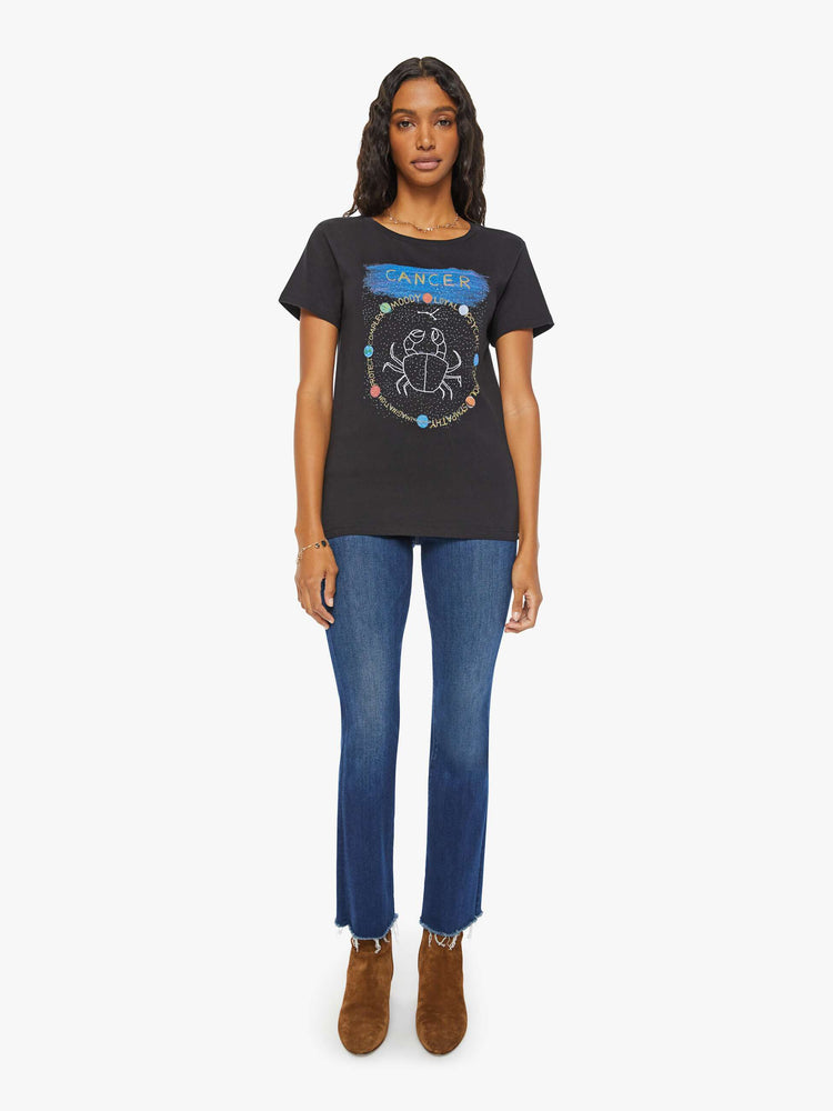 Full body view of a woman in a black tee features the crab of the Cancer, the fourth astrological sign in the zodiac.