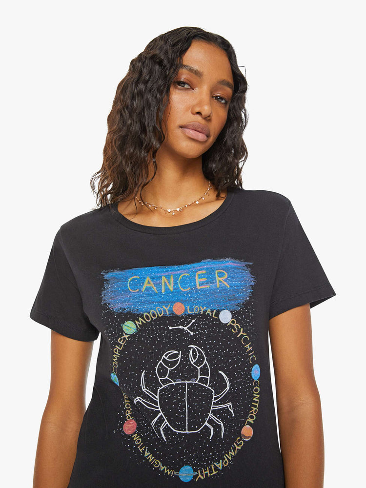 Close up view of a woman in a black tee features the crab of the Cancer, the fourth astrological sign in the zodiac.