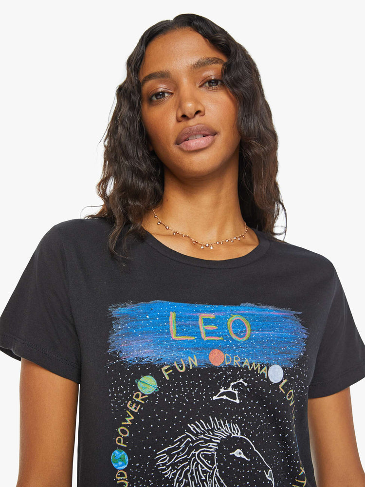 Close up  view of a woman in a black tee features the Leo lion, the fifth astrological sign in the zodiac.