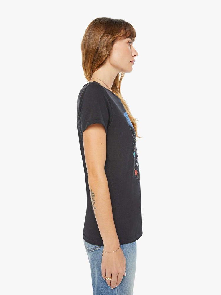 Side view of a woman black tee features the Libra scale, the seventh astrological sign in the zodiac.