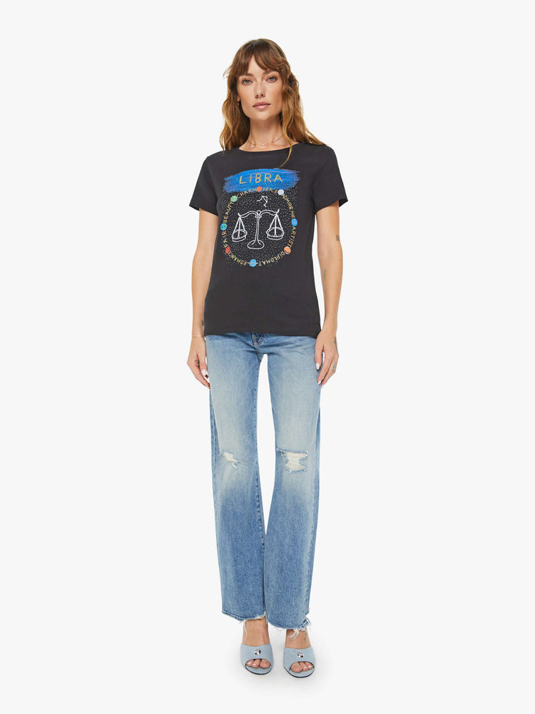 Full body view of a woman black tee features the Libra scale, the seventh astrological sign in the zodiac.