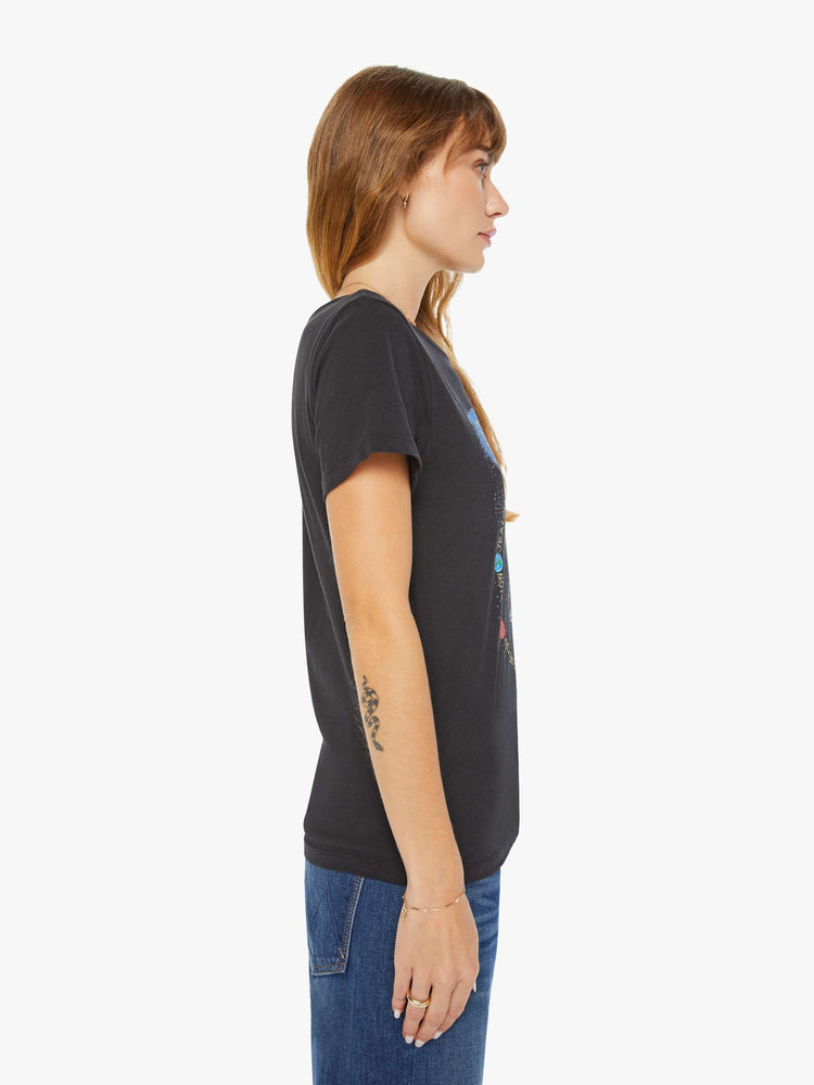 Side view of a woman black tee features a scorpion, the symbol of the eighth astrological sign in the zodiac, Scorpio.