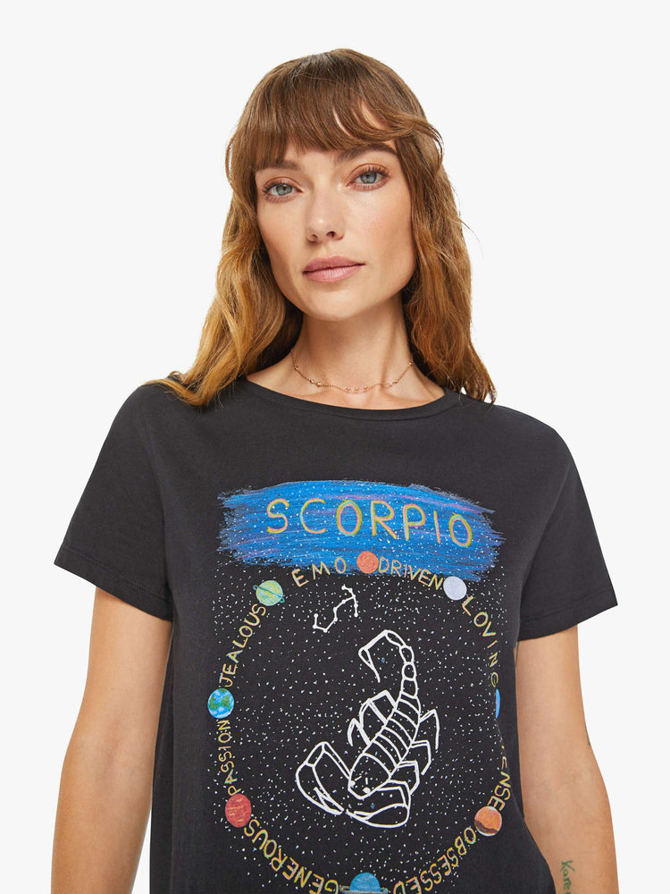 Close up view of a woman black tee features a scorpion, the symbol of the eighth astrological sign in the zodiac, Scorpio.