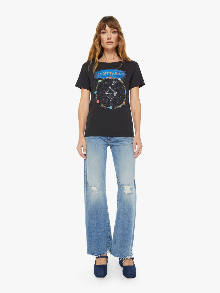Full body view of a woman black tee features an archer, the symbol of the Sagittarius.