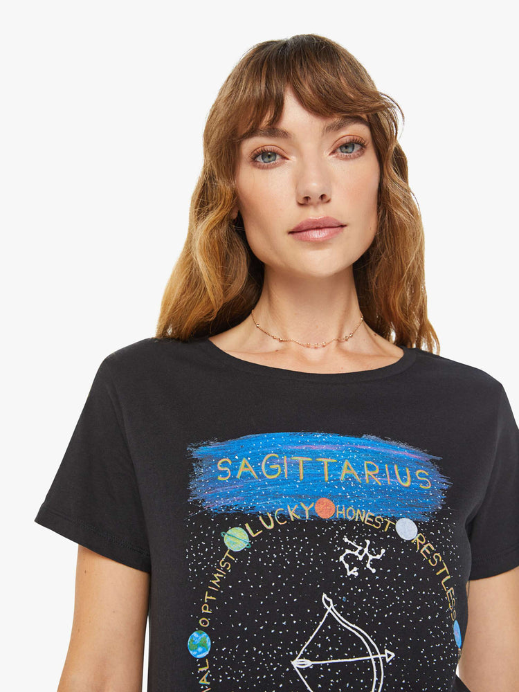 Close up view of a woman black tee features an archer, the symbol of the Sagittarius.