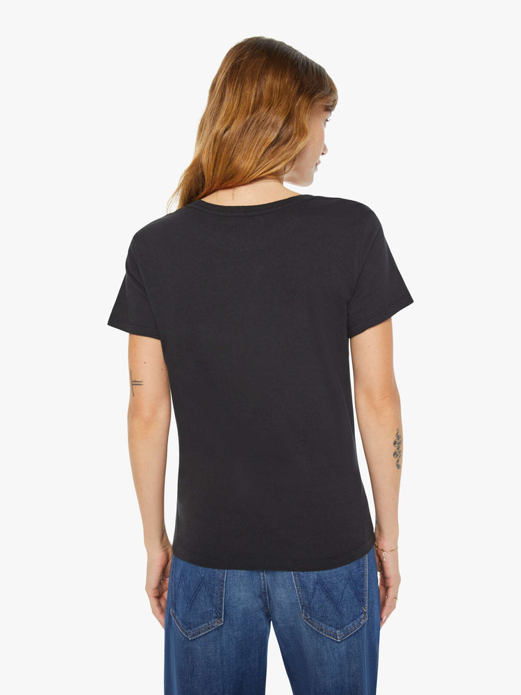 Back view of a woman black tee features a sea-goat, the symbol of the Capricorn.
