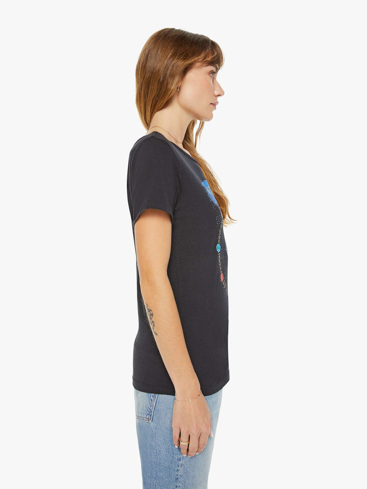 Side view of a woman black tee features a water jar symbolizing the sign of the Aquarius.