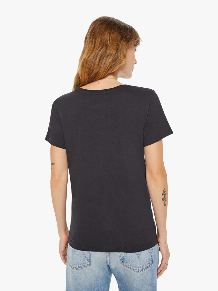 Back view of a woman black tee features a water jar symbolizing the sign of the Aquarius.