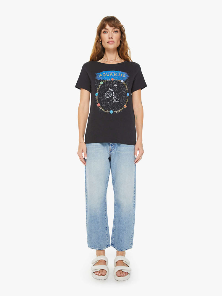 Full body view of a woman black tee features a water jar symbolizing the sign of the Aquarius.