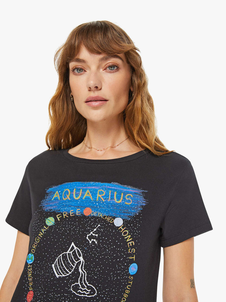 Close up view of a woman black tee features a water jar symbolizing the sign of the Aquarius.