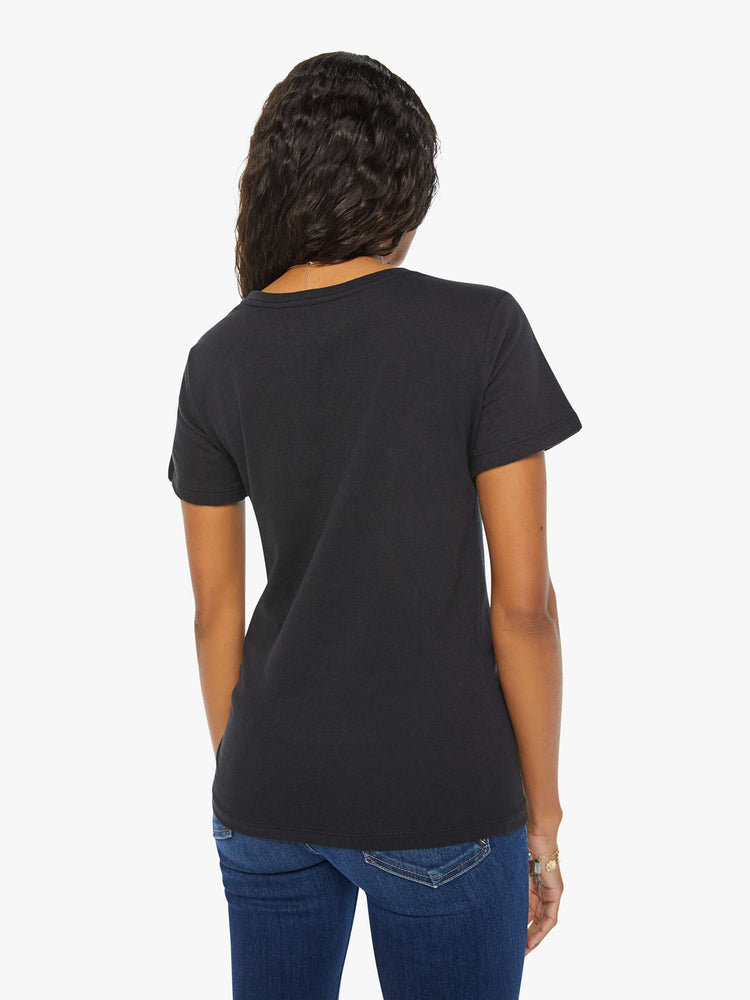 Back view of a woman black tee features the symbol of the water sign, Pisces — two fish swimming in opposite directions.