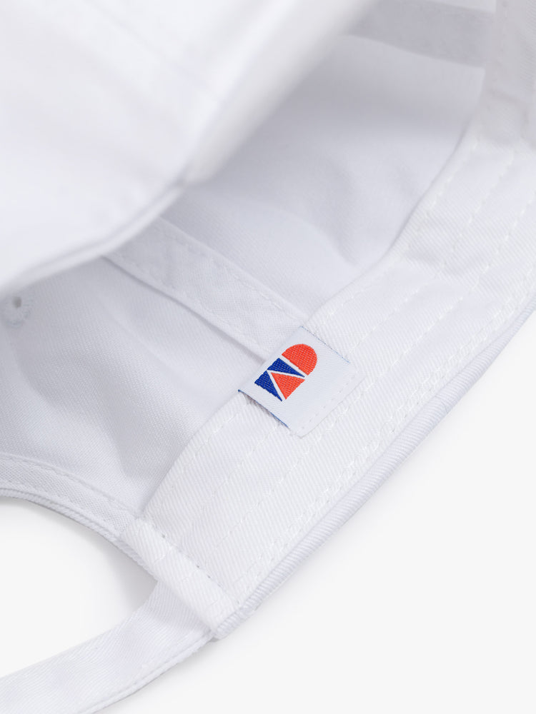 Detail of a red and blue label inside a white hat.