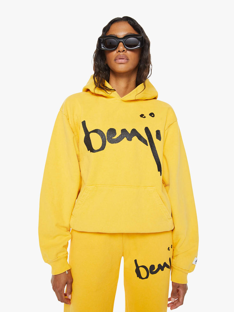 WOMEN front view of a mustard yellow patch pocket, ribbed hems and a slightly oversized sweatshirt.