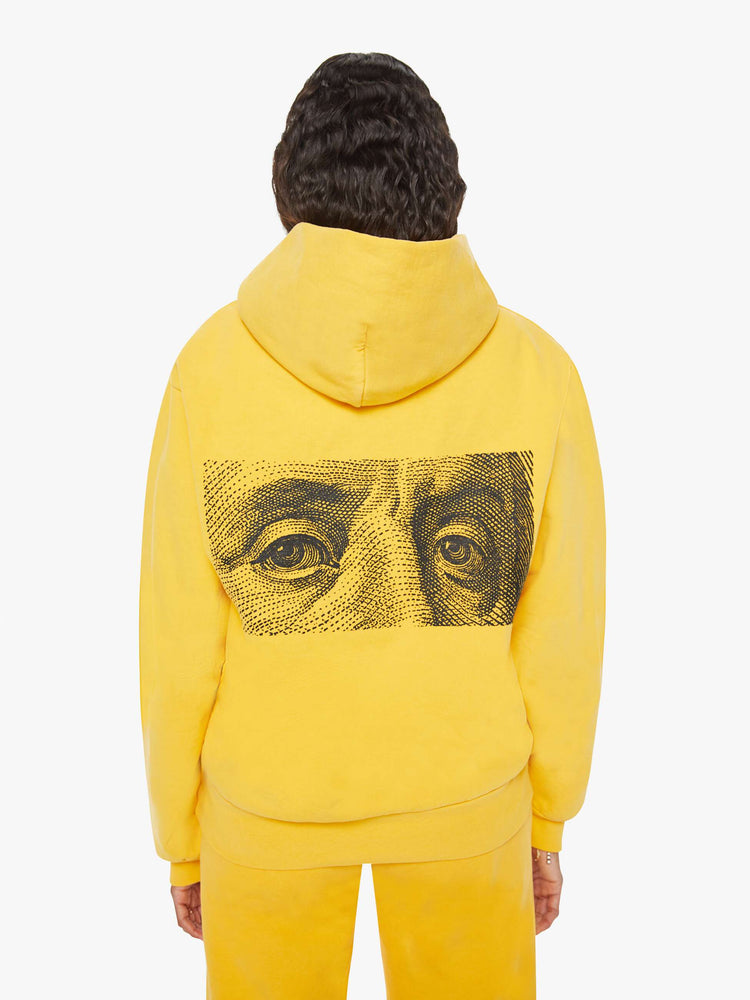 WOMEN back view of a mustard yellow patch pocket, ribbed hems and a slightly oversized sweatshirt.