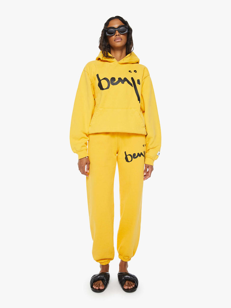 WOMEN full body view of a mustard yellow patch pocket, ribbed hems and a slightly oversized sweatshirt.