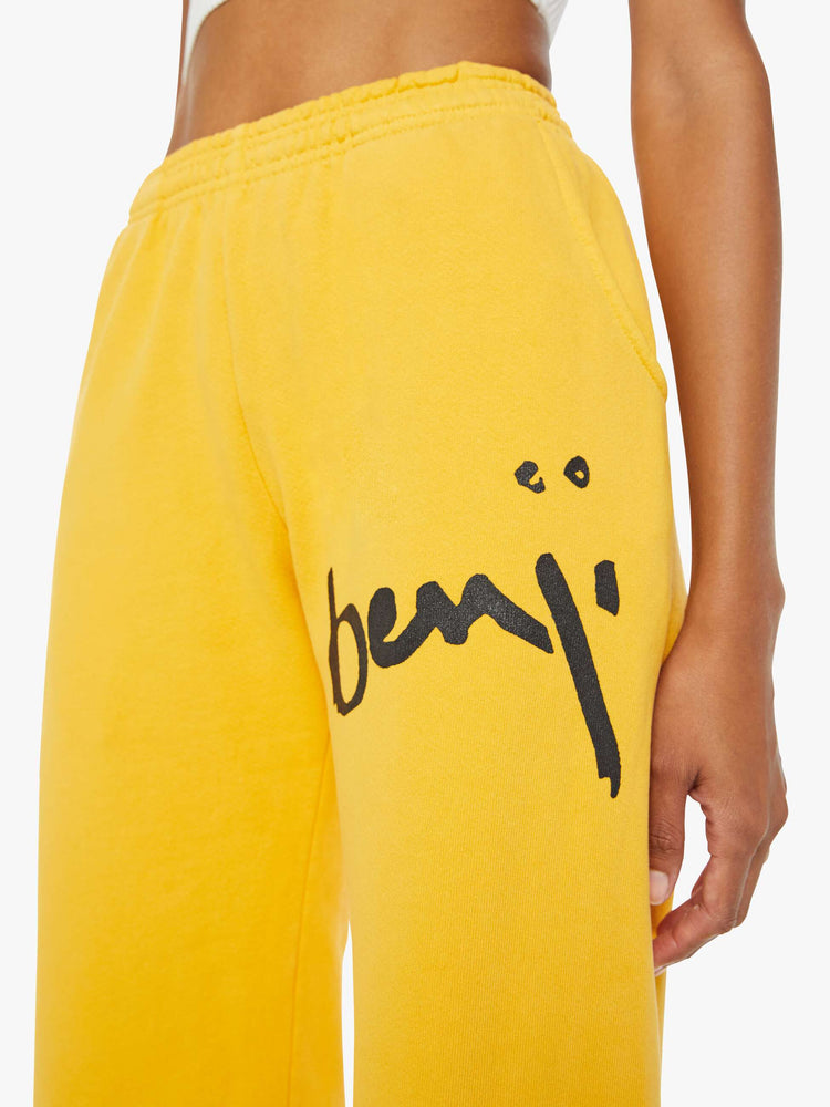 WOMEN Close view of a woman mustard yellow elastic waist and cuffs sweatpants with founding fathers eyes on the back.