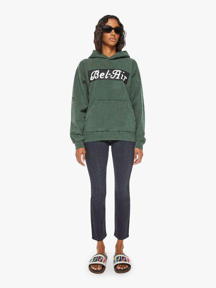 WOMEN full body sweatshirt in forest green has a front patch pocket, ribbed hems and a slightly oversized fit referencing the Los Angeles Neighborhood.