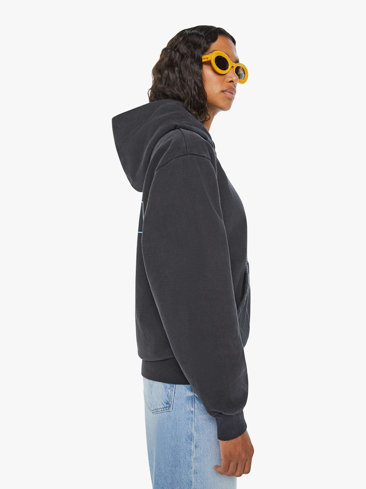WOMEN side view of black front patch pocket, ribbed hems and a slightly oversized fit sweatshirt with "Help Wanted" graphic and cross on the back.