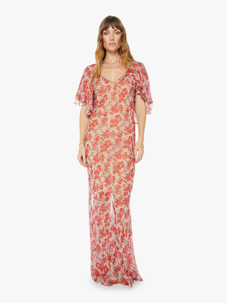 Front view of a floor length flowy dress in a nude and red floral print, featuring a deep v neck and winged sleeves.