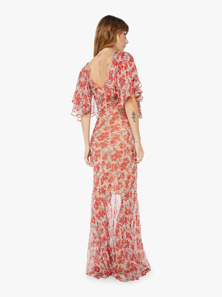 Back view of a floor length flowy dress in a nude and red floral print, featuring a deep v neck and winged sleeves.