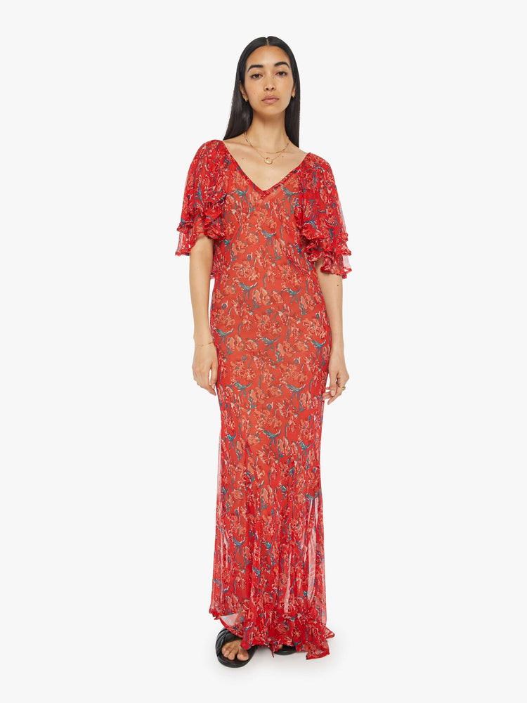 Front view of womens long dress featuring a red floral print, a deep v neck, and ruffled sleeves.