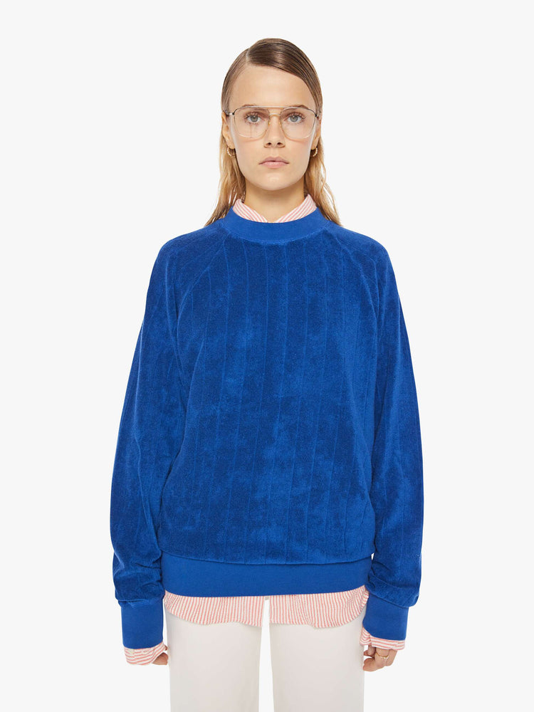 Front view of a womens ribbed sweatshirt featuring raglan sleeves and an oversized fit.