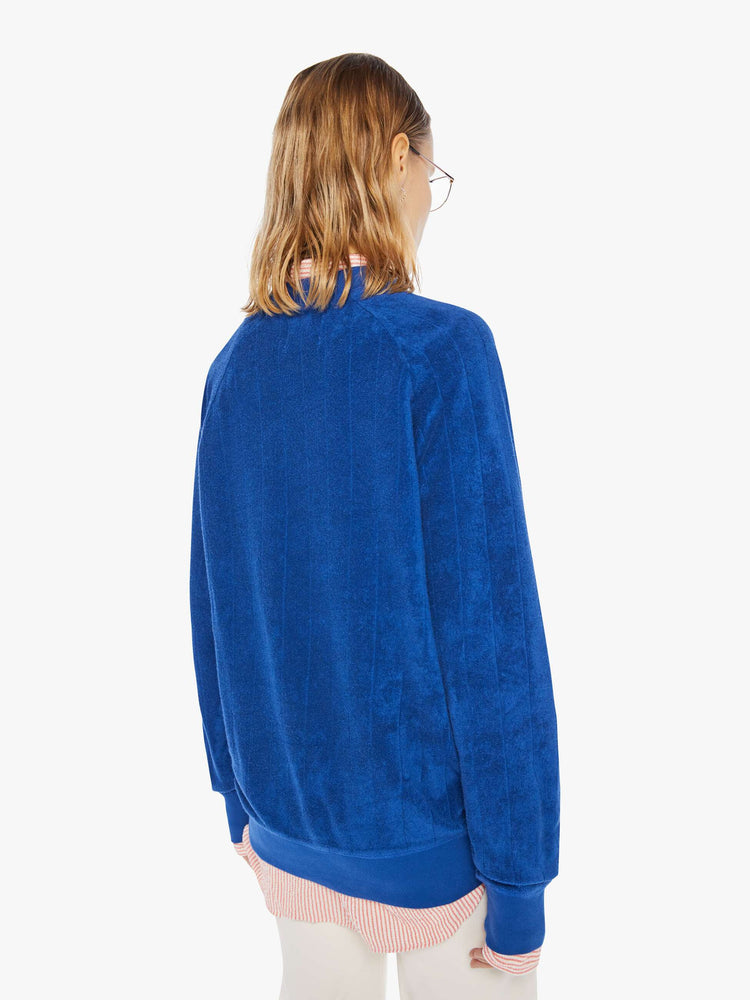 Back view of a womens ribbed sweatshirt featuring raglan sleeves and an oversized fit.