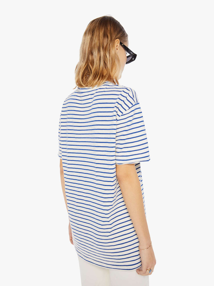 Back view of a womens white crew neck tee with blue stripes and an oversized fit.