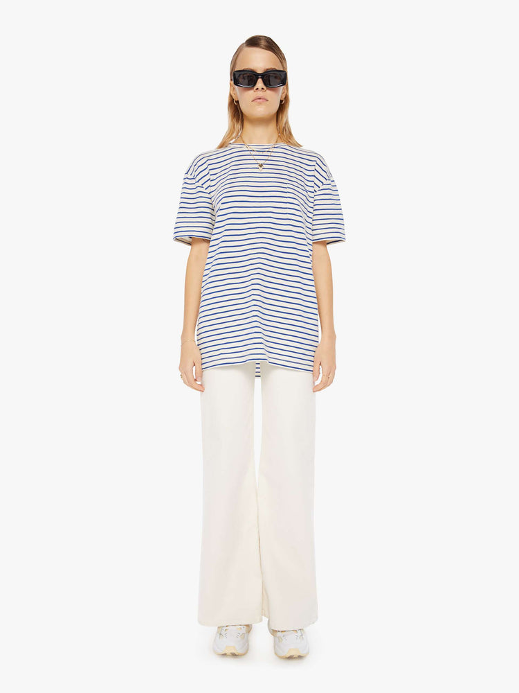Front full body view of a womens white crew neck tee with blue stripes and an oversized fit.